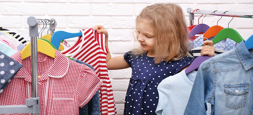 Little girl trying on a new dress